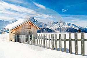 Little cottage covered with snow in the high Dolomites mountains