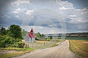 Little country church beside a gravel road in summertime