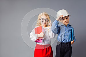 The little couple in costumes of teacher and engineer