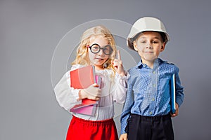 The little couple in costumes of teacher and engineer