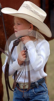 Little Cowgirl Adjusting Her Hat