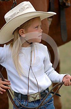 Little Cowgirl Holding Reins photo