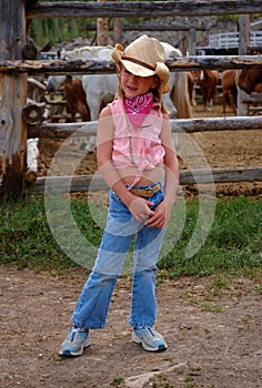 Little Cowgirl with Horse Corral Background