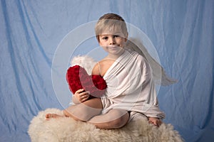 Little cupid toddle boy, holding bow and arrow, beautiful blond cherub