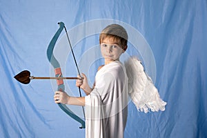 Little cupid toddle boy, holding bow and arrow, beautiful blond cherub