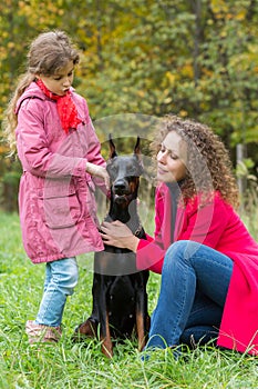 Little curly girl and her mother are caress the photo