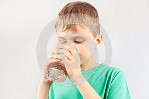 Little cut boy drinking fresh mineral water
