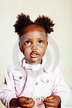 Little cute african american girl playing with animal toys at ho