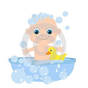 Little cute baby bathes in a bathtub with soap bubbles and a yellow rubber duck.