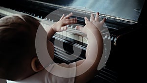 Little cute baby boy climbs on his own on beautiful armchair in slow motion