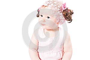 Little cute baby-girl with blue eyes in pink dress isolated on white background