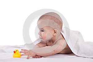 Little cute baby playing with yellow duck after shower, isolated