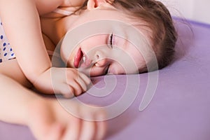 Little cute baby sleeping soundly in her bed