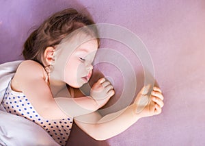 Little cute baby sleeping soundly in her bed