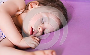 Little cute baby sleeping soundly in her bed