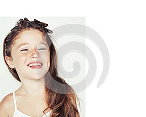 Little cute beauty girl isolated on white background holding flower lily in her hair, close up adorable kid