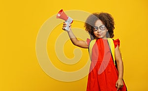 Little cute Black girl in red dress holding in hand and speaking in electronic red and gray megaphone