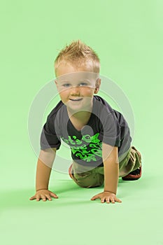 Little cute blond boy crawling, smiling