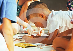 Little cute boy with company painting on birthday party