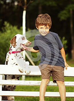 Little cute boy with dalmatian dog