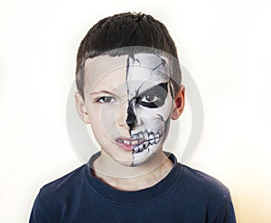 Little cute boy with face paint like skeleton to celebrate halloween, lifestyle people concept