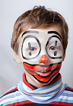 Little cute boy with facepaint like clown,