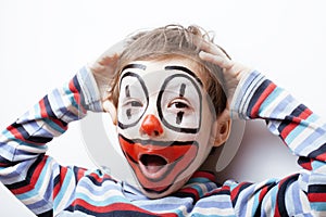 Little cute boy with facepaint like clown,