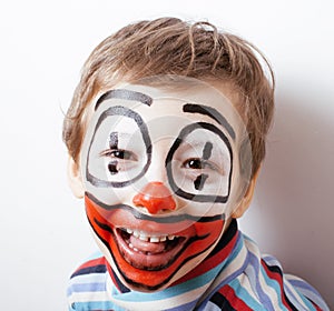 Little cute boy with facepaint like clown