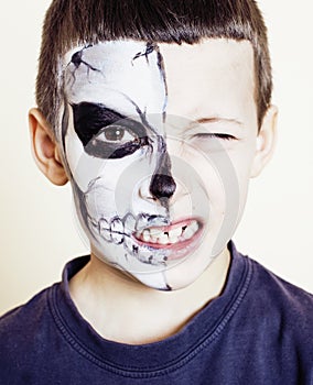 Little cute boy with facepaint like skeleton to celebrate hallow