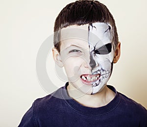 Little cute boy with facepaint like skeleton to celebrate halloween