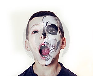 Little cute boy with facepaint like skeleton to celebrate halloween, lifestyle people concept, children on holiday