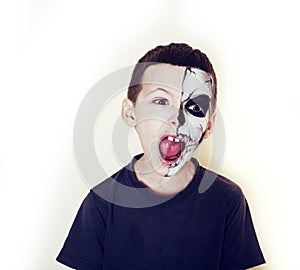 Little cute boy with facepaint like skeleton to celebrate halloween, lifestyle people concept, children on holiday