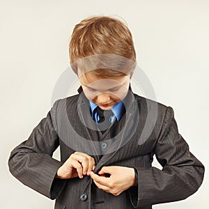 Little cute boy fastened business suit