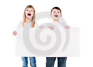 Little cute boy and girl holding an empty paper sheet