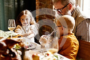 Little cute boy and girl, kids visit grandparents and celebrate Thanksgiving day at home, indoors. Family, holiday