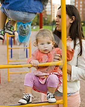 Little cute boy and girl playing outside, adorable friendship, baby todler with carying mother, lifestyle people concept