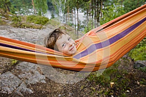 Little cute boy in hammock smiling