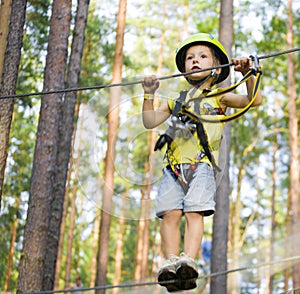 Little cute boy in helmet runs track