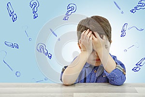 Little cute boy and his questions on light background