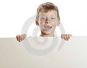 Little cute boy holding empty shit to copyspace