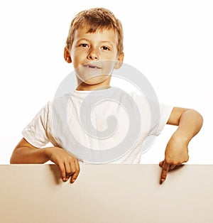 Little cute boy holding empty shit to copyspace close up gesturing smiling