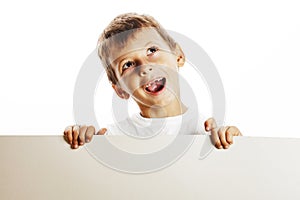 Little cute boy holding empty shit to copyspace isolated close u