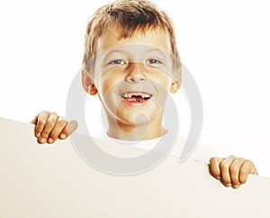 Little cute boy holding empty shit to copyspace isolated close up gesturing smiling