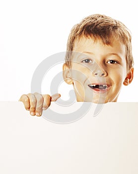 Little cute boy holding empty shit to copyspace isolated close up gesturing smiling