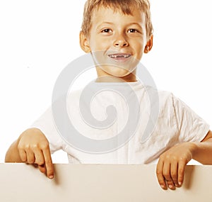 Little cute boy holding empty shit to copyspace isolated close up gesturing smiling