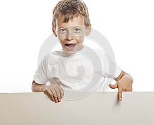 Little cute boy holding empty shit to copyspace isolated close up gesturing smiling