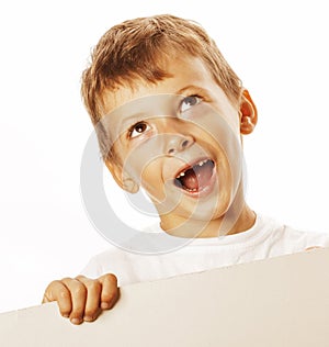 Little cute boy holding empty shit to copyspace isolated close up gesturing smiling