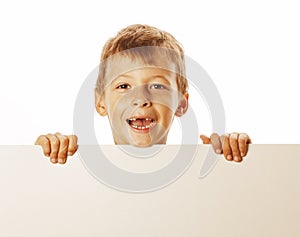 Little cute boy holding empty shit to copyspace isolated close up gesturing smiling