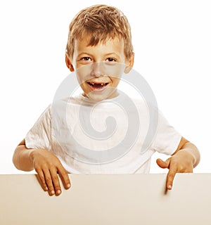 Little cute boy holding empty shit to copyspace isolated close up gesturing smiling