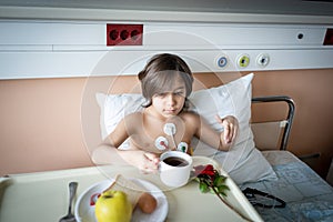 Little cute boy in hospital at bed